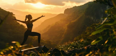 Poster Silhouette fitness girl meditating on the mountain © AlfaSmart
