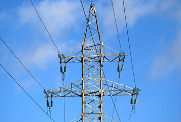 power lines of blue skyTop section of high-voltage power line metal prop on clear blue sky as...