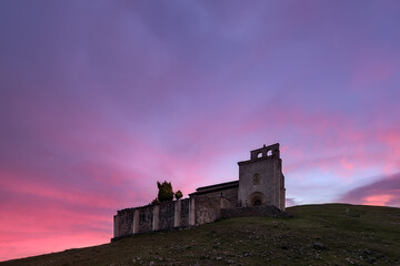 Obraz premium Hermitage of San Pantaleón de Losa in the Losa valley, Burgos, with a sky of intense colors