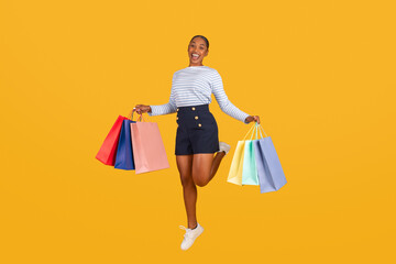 Happy young african american woman with shopping bags
