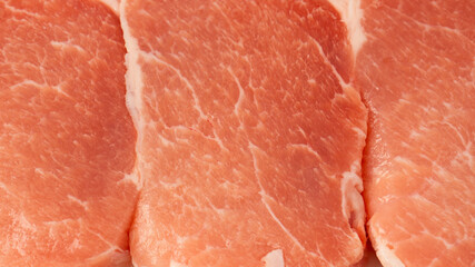 Raw pork pieces isolated on a white background.