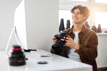 Happy male photographer reviewing images on DSLR camera