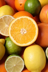 Different fresh citrus fruits as background, closeup