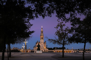 Sunset over Fatima Sanctuary in Portugal. Basilica of Our Lady of the Rosary filmed against rose blue sky before night. Religious travel to Portugal.