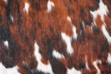 Spotted white brown red orange hair cow fur texture background