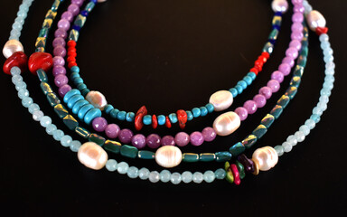 pearls and beads necklaces on black background