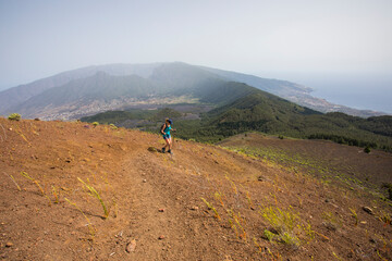 Fototapeta premium A young woman walking towards Birigoyo peak, La Palma Island, Canary Islands.