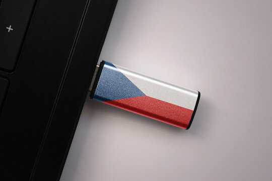 usb flash drive in notebook computer with the national flag of czech republic on gray background.