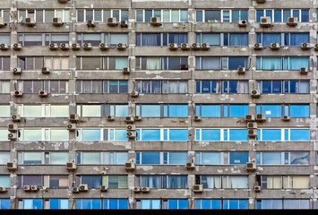 Apartment prefabricated building in Russia with many air conditioning units on the facade.
