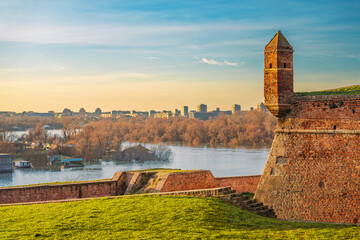 golden hues of sunset atop Belgrade's Kalemegdan fortress, where visitors are greeted by historic...