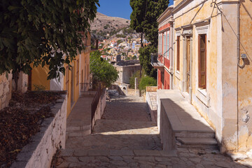 Old narrow traditional street in the Greek village of Symi. - 755859403