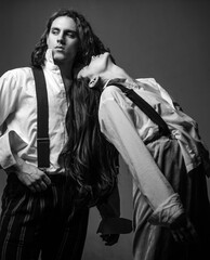 Fashion studio photo of beautiful couple in suit. In white shirt. Beautiful adult couple in formal...