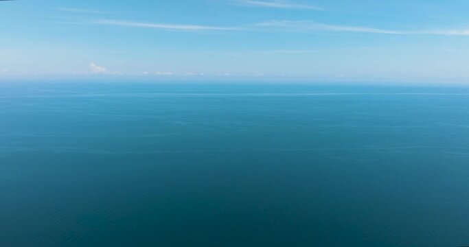 Beautiful white clouds on blue sky over calm sea. Flight over the sea. Indonesia.