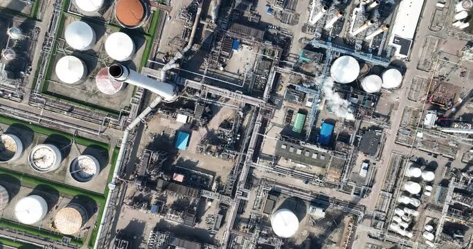 Petroleum refinery petrochemical complex in Pernis, in the port of Rotterdam, The Netherlands. Aerial drone view. Crude oil is processed into useful products such as gasoline, kerosene, diesel and raw