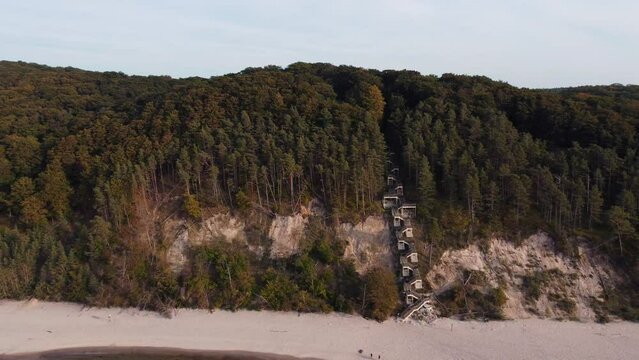 Stairs leading up to a forest on a coast