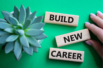 Build new career symbol. Concept word Build new career on wooden blocks. Businessman hand....