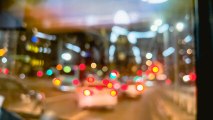 Defocused city lights at night. Blurry bokeh shiny sparkles of red and golden lights of traffic. Cars behind bus window. film grain pixel texture. soft focus. blur.  - obrazy, fototapety, plakaty