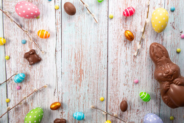 Chocolate eggs, chocolate bunny and sweets on wooden table.Greetings card, Happy Easters. Flat lay ,top view