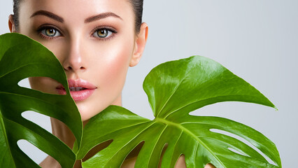 Beautiful woman with green leave near face and body.  Closeup girl's face with green leave. Skin care beauty treatments concept. - 755889420