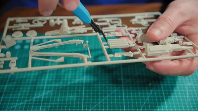 Cutting off a plastic model airplane with nippers