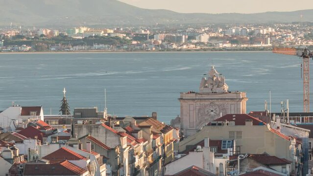 Aerial view of Lisboa downtown timelapse during sunset. Panoramic of Baixa, Rossio and Chiado red rooftops from above. Arch on the Augusta street. Almada on the other side of Tejo river. Portugal
