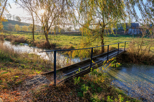 A bridge over a river with a fence in the background