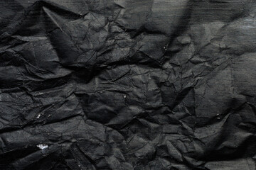 Crumpled paper canvas painted with black paint. Blank for design, graphic resource