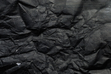 Fototapeta premium Crumpled paper canvas painted with black paint. Blank for design, graphic resource