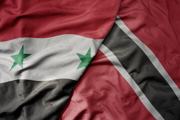 big waving national colorful flag of trinidad and tobago and national flag of syria .