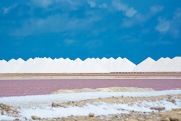 Pink water and salt pyramids at the Bonaire Salt Ponds.