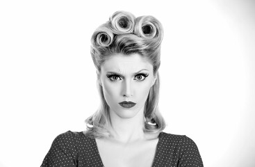 Serious young woman. Crazy furious young pin up woman standing over white background. Pin up woman portrait. Beautiful retro female with red lips and old fashion hairstyle.