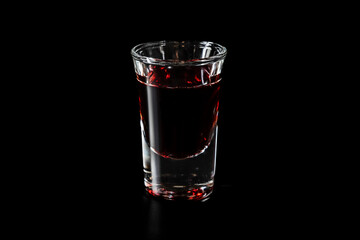 Shot glass with red drink
