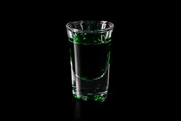 Shot glass with green drink