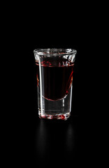 Shot glass with red drink