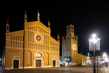 Naklejka premium Night view of Cathedral of Piove di Sacco and Carrarese Tower at Piazza Incoronata (Incoronata Square); Veneto, Italy
