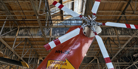 large propeller on vintage plane helicopter being restored (new paint) inside airplane hanger...