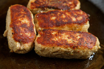 Lula lamb cutlets fried in a frying pan close-up.