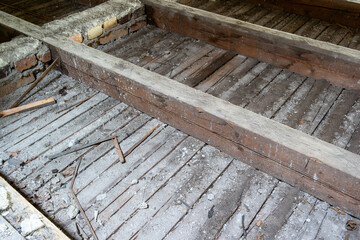 Renovation of an old attic with a wooden floorboard and wooden beams