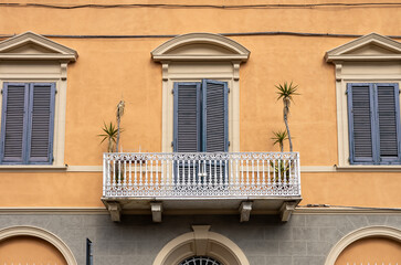 Close view on the facade of a traditional building in Italy. Beautiful house with balcony in old...