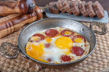 Turkish Sausage (sucuk) and egg. Turkish breakfast food sucuklu yumurta , Turkish omelette with sucuk. - obrazy, fototapety, plakaty