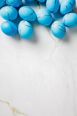 Blue Easter eggs on marble background. Flat lay, top view.