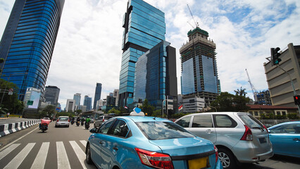 Jakarta's roads and streets with cars during the daytime.
