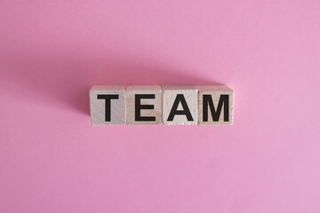 Word team on wooden block, relationship of collaboration and leadership for success, group of...