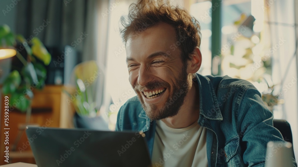 Aufkleber A man smiling while looking at a laptop. Suitable for technology and business concepts.