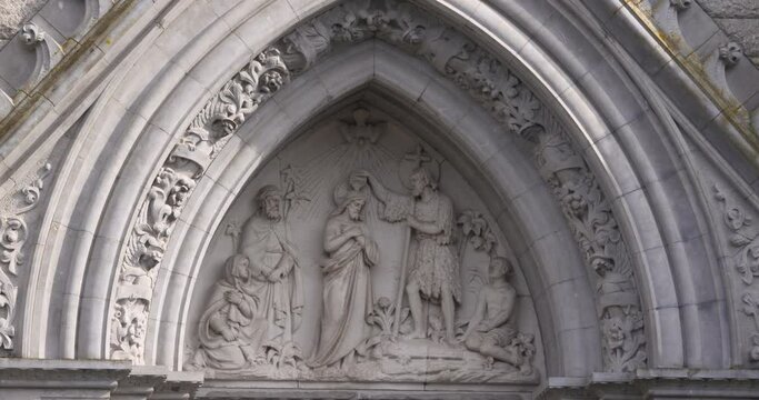 Sculpture of baptism scene gothic religious art porch arch Jesus Saint John