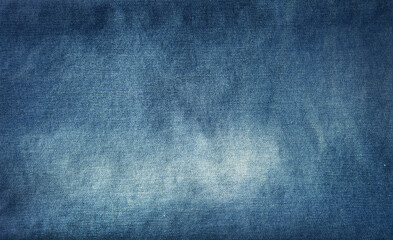 Close-up of faded blue denim jeans fabric texture background