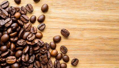 Café mania. Top view of a traditional coffee beans on a rustic wooden table and various beans scattered across the surface. Touch of caffeine at home. Cafe style and Copy space.