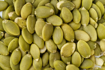 Nutritious nut pumpkin seeds on white background