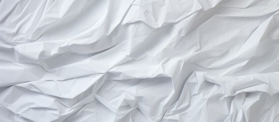 Obraz premium A close up of a white silk sheet with a subtle grey pattern on a wooden bed. The monochrome photography captures the tints and shades of the linens, giving a sense of elegance and luxury to the event