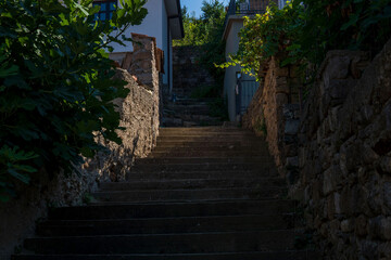 Daylight dynamics. Concrete staircase and alley street. Light and shadow. Contrast.
